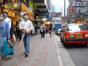 Residents of Hong Kong wear masks during the SARS epidemic in 2003. Photo by faux-tographer on Flickr.